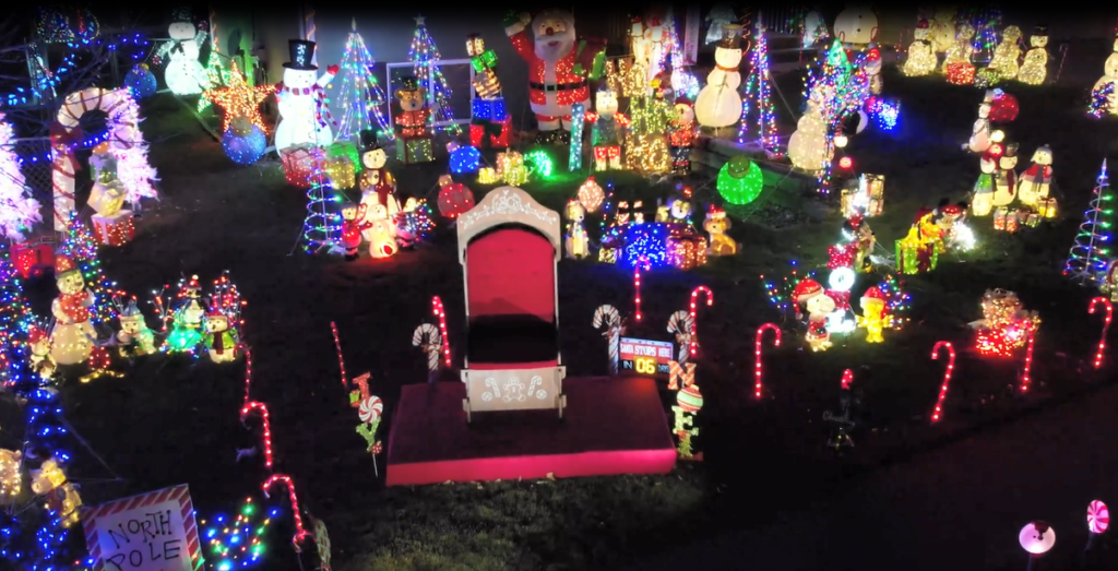 A house surrounded by Christmas lights and figures
